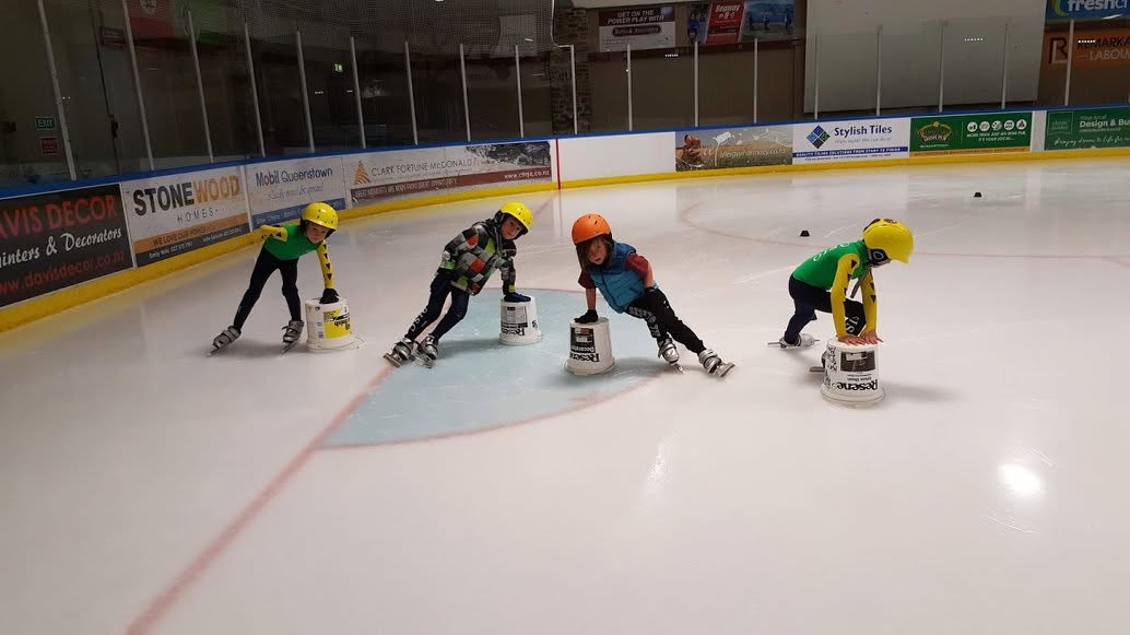 Olympic Ice Sports Club Junior skaters practicing with buckets
